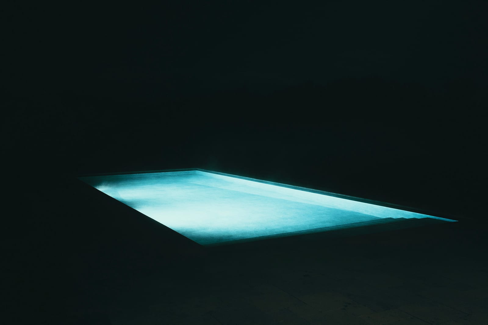 Clear pool water over a freshly finished pool interior.